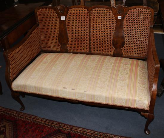 A 1930s walnut bergere settee, W.122cm